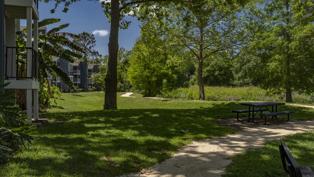 a picnic table in a park next to a building