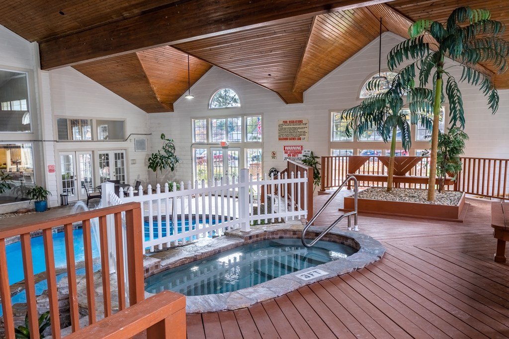 a hot tub is in the middle of a house with a porch