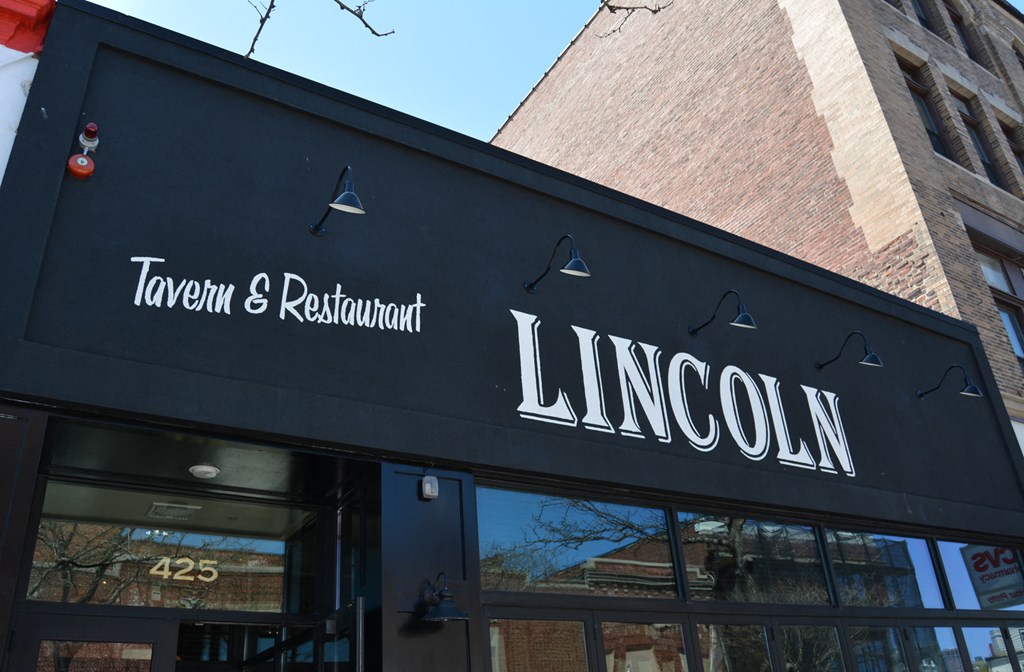 a sign tavern and restaurant in front of a building