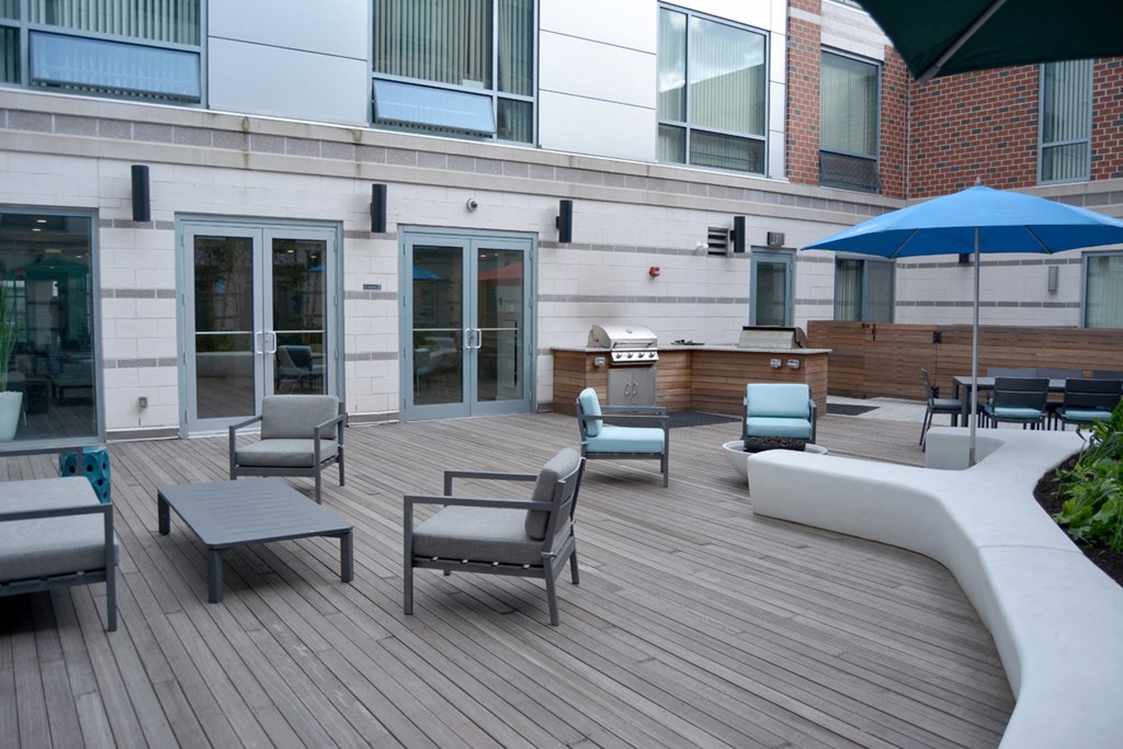 a large patio with tables and chairs and an umbrella