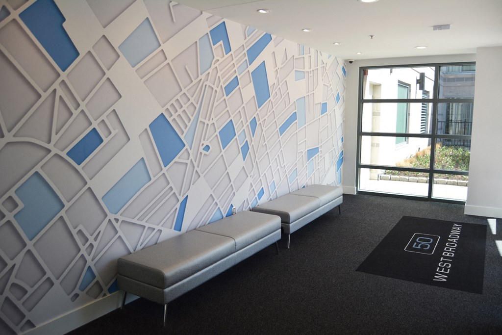 a group of benches in a room with a wall