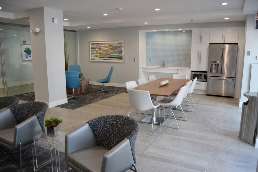 a dining room with a table and chairs and a kitchen