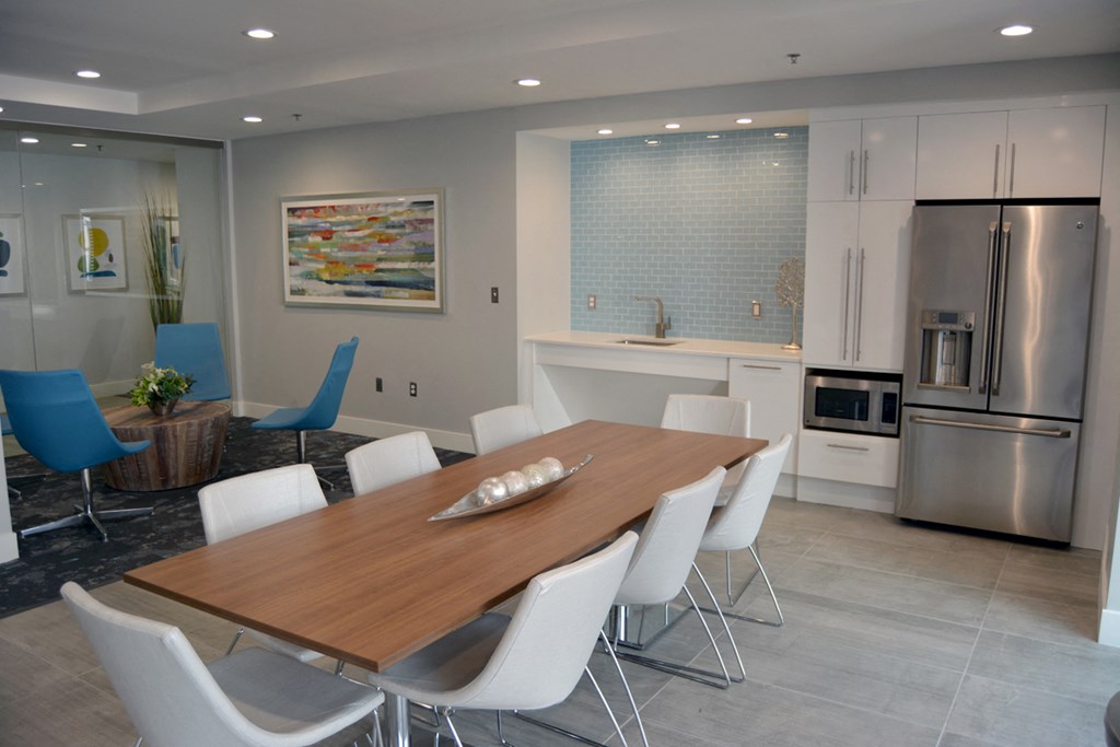 a dining room with a wooden table and white chairs