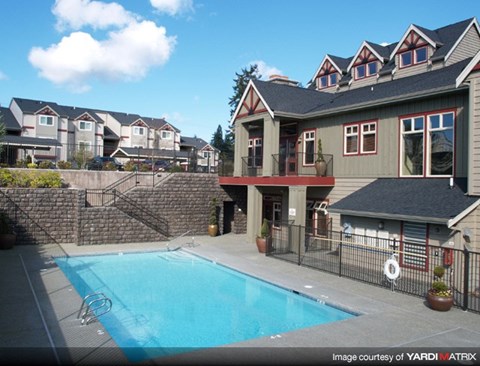 a swimming pool in front of a house