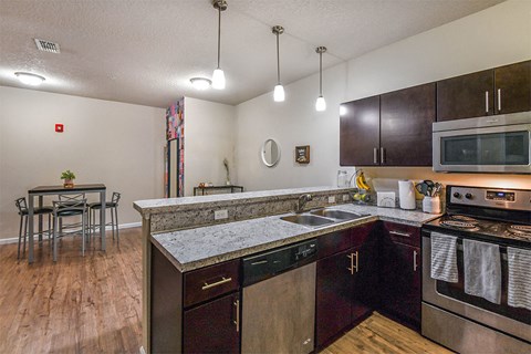 a kitchen with stainless steel appliances and a counter top