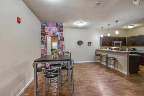a kitchen with bar stools and a counter top