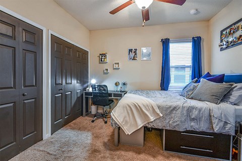 a bedroom with a bed and a desk