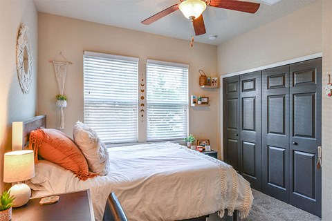 a bedroom with a bed and a ceiling fan
