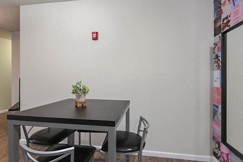 a dining room with a table and three chairs