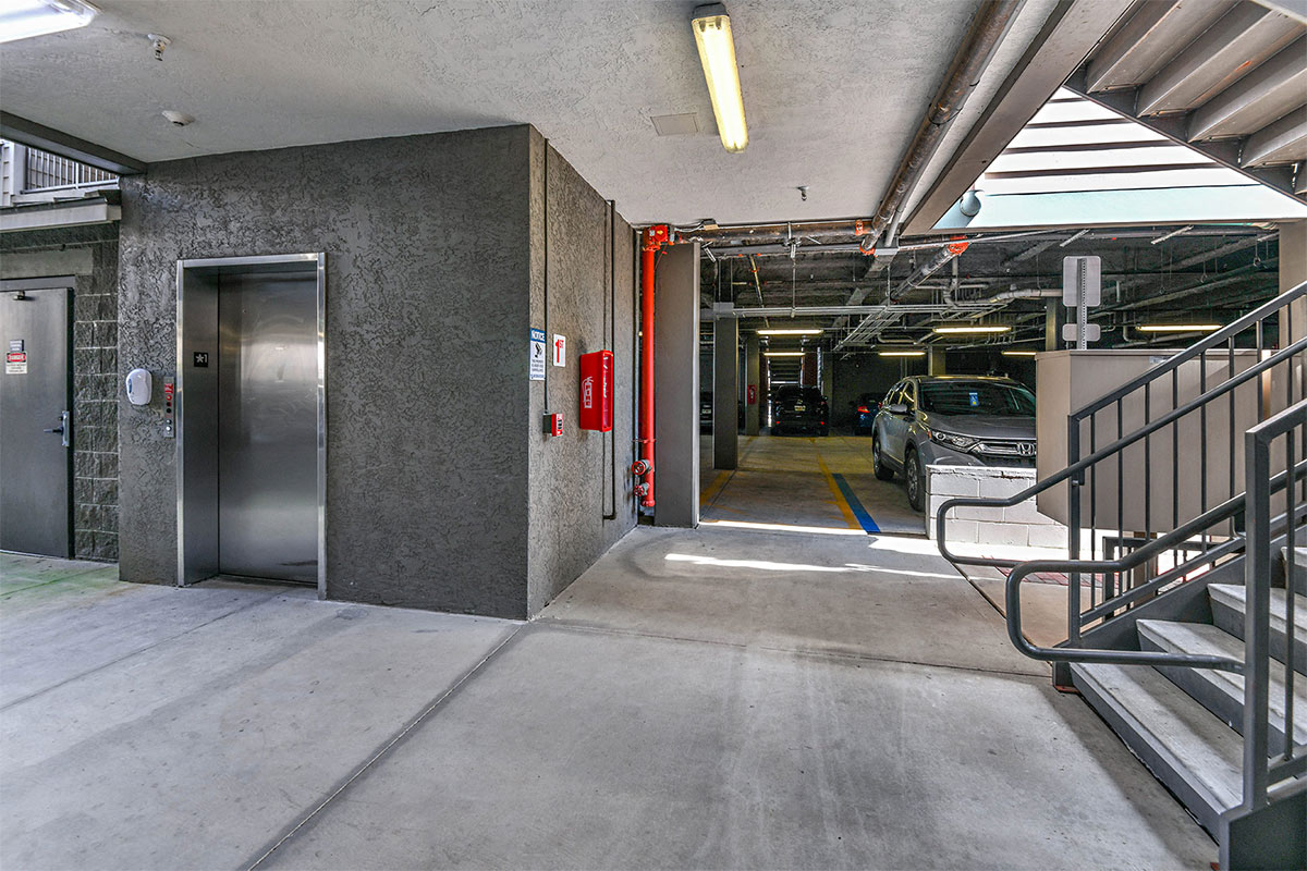 a parking garage with an elevator and stairs