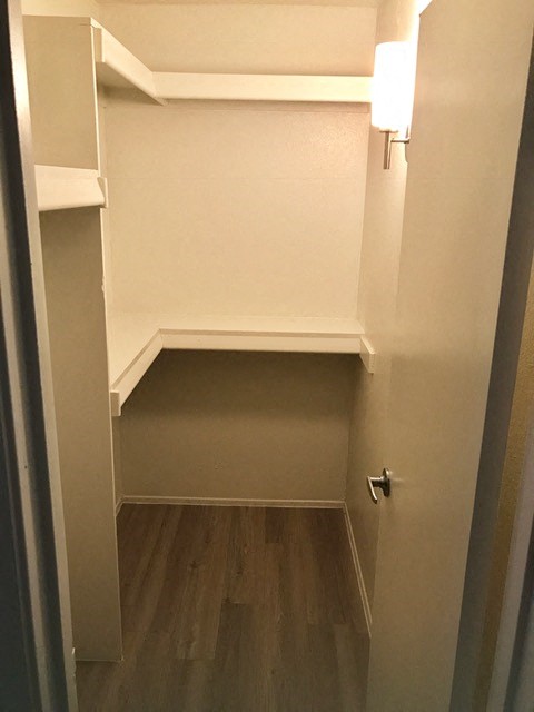 a small room with a closet and a door