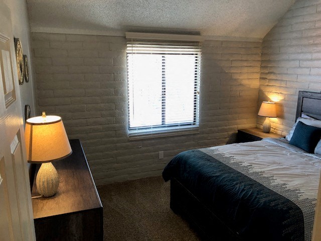 a small bedroom with a bed and a window