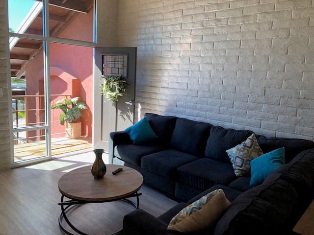 a living room with a blue couch and a table
