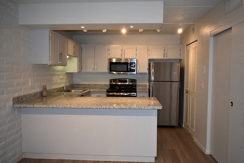 a kitchen with a counter top and a refrigerator