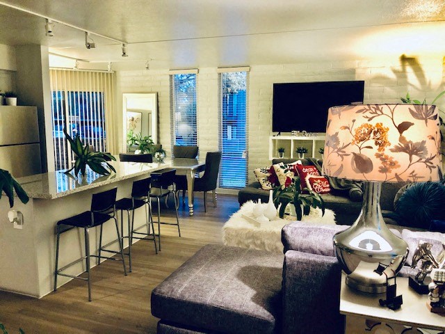 a living room with a bar and a kitchen