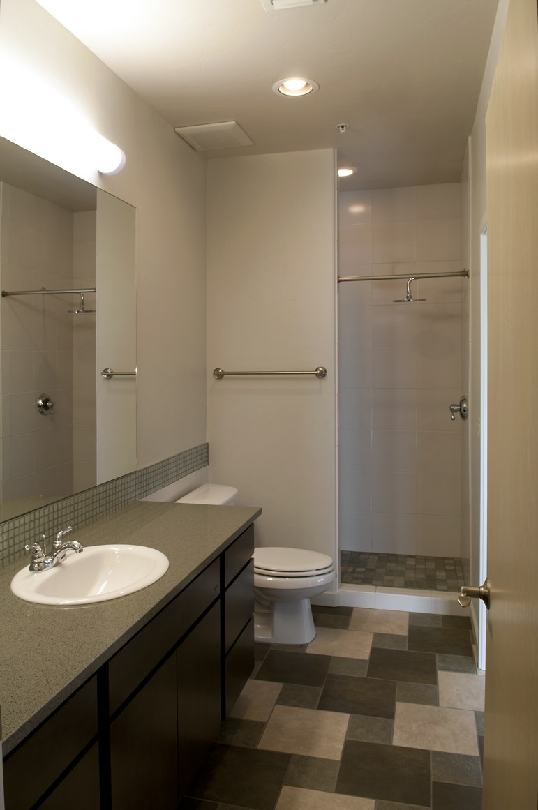 a bathroom with a toilet and a sink and a shower