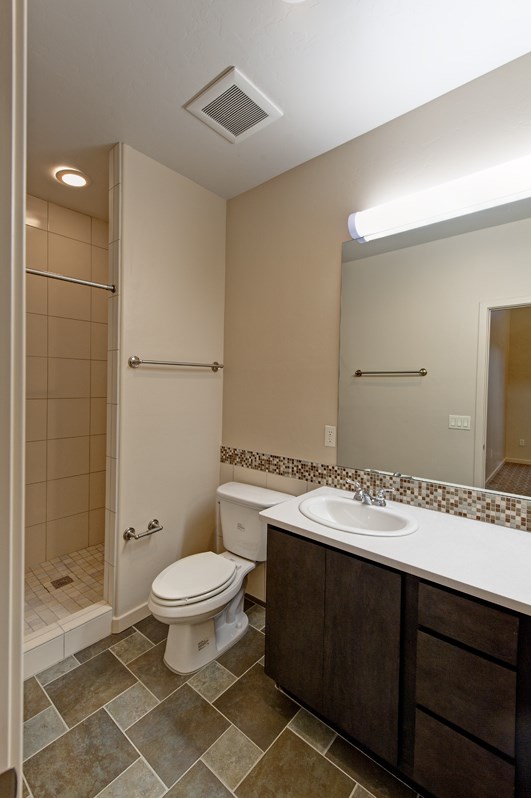 a bathroom with a toilet and a sink and a shower