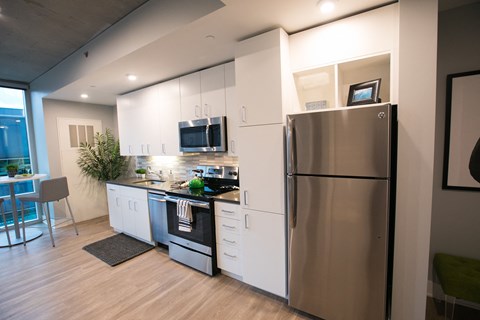 a kitchen with stainless steel appliances and a refrigerator