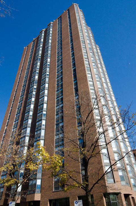 a tall building with many windows against a blue sky