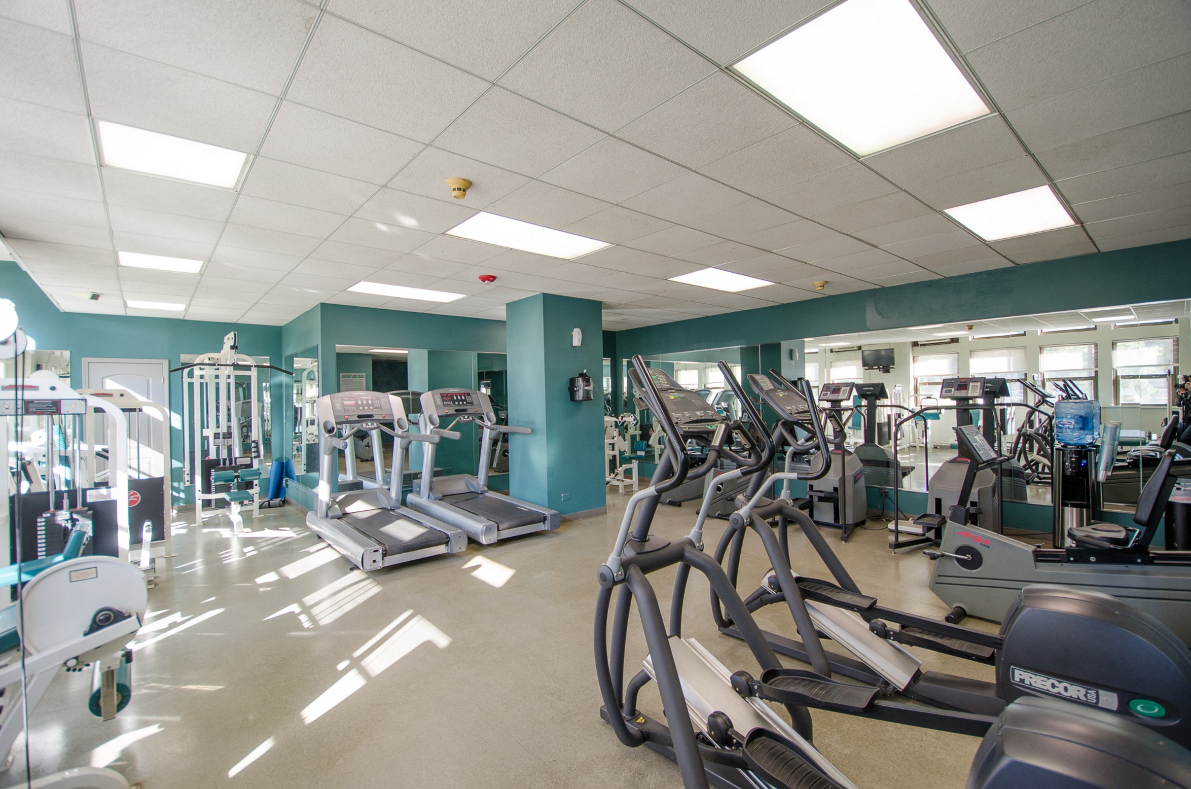 a gym with a lot of exercise equipment in it