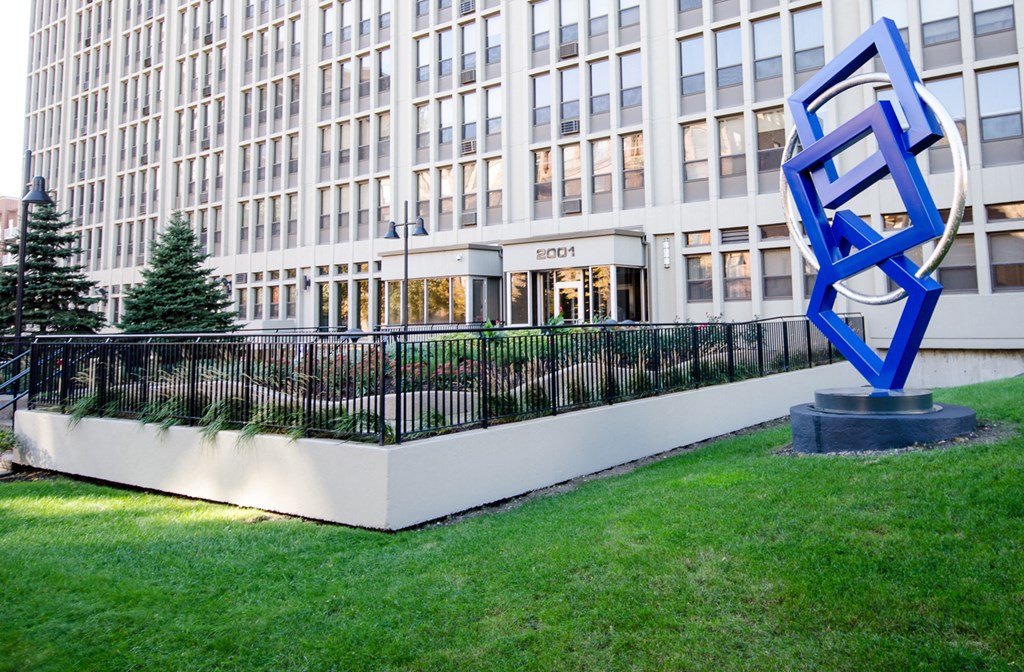 a large blue sculpture in front of a building
