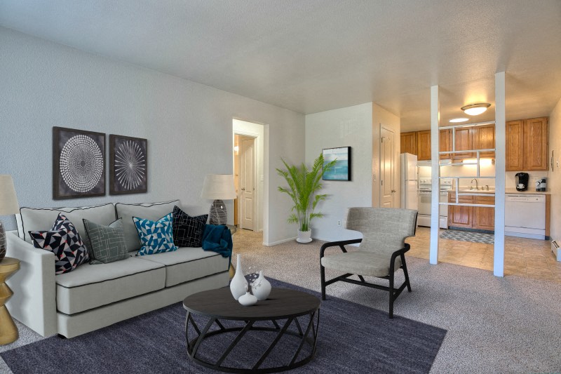 a living room with a couch and a chair and a table