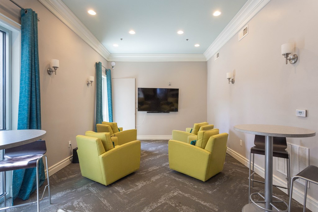 a living room with couches and tables and a television