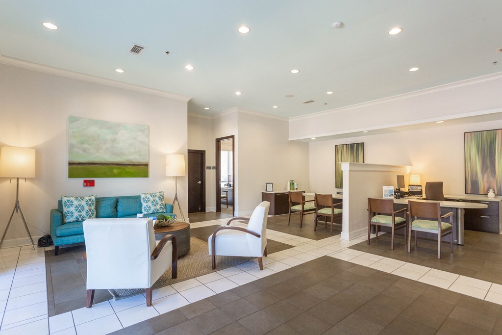 a living room with a couch and chairs and a dining room table