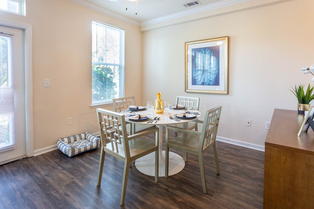a dining room with a table and chairs and a window