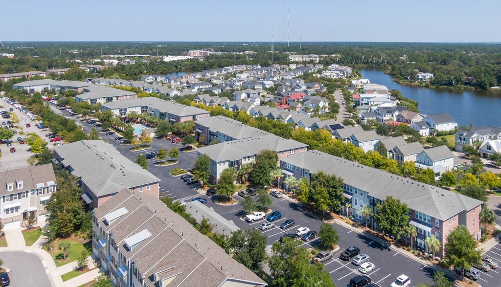 an aerial view of a neighborhood of houses next to a river