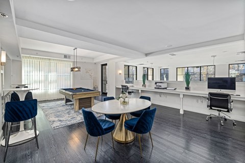 a living room with a table and chairs and a pool table