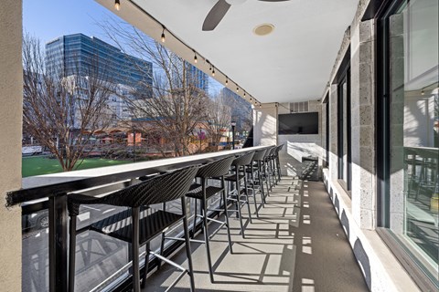 a row of chairs on a balcony overlooking a city