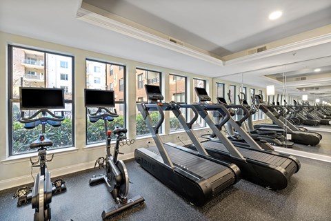 a gym with treadmills and other exercise equipment