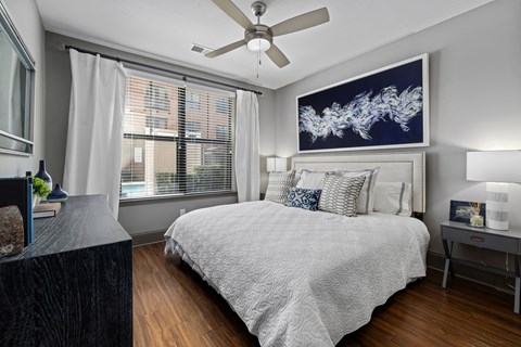 a bedroom with a bed and a ceiling fan
