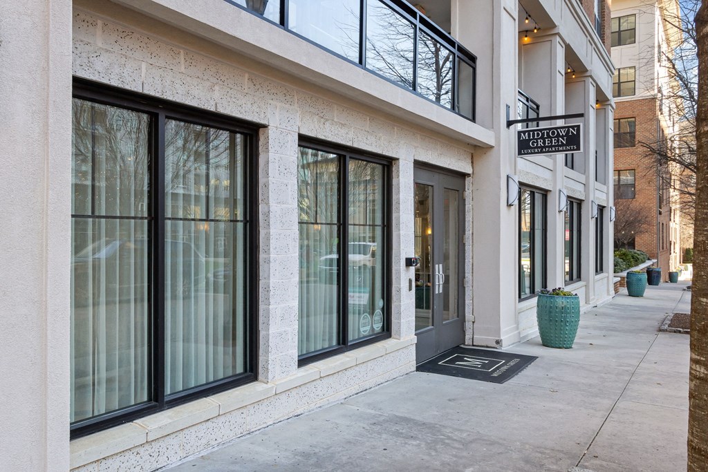 the front of a building with windows and a sidewalk