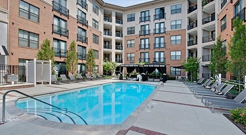 a swimming pool in front of an apartment building
