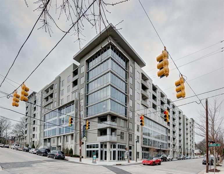 a large building on the corner of a street with traffic lights