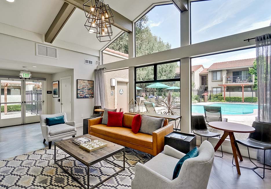 a living room with a couch and chairs and a pool