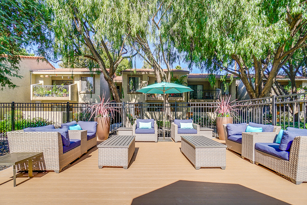 San Jose, CA, Apartments - Villas Willow Glen - Gated Outdoor Lounge With Plush Couches, Tables, Potted Plants, And Maintained Landscaping