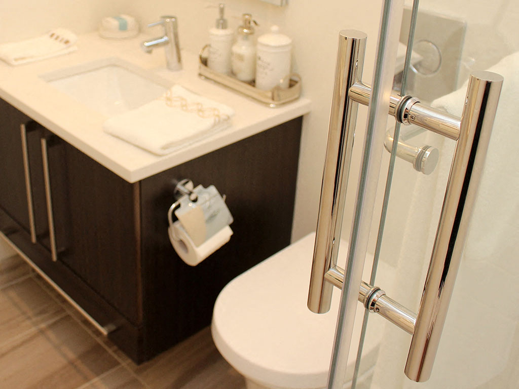 a bathroom with a toilet and a sink and a shower