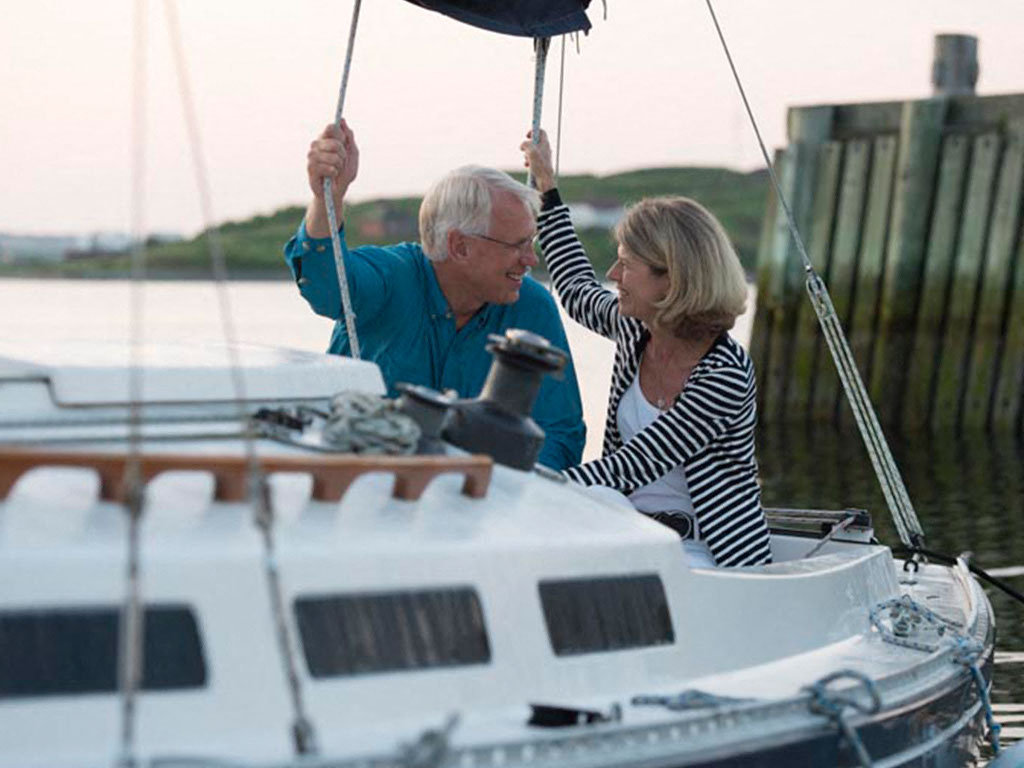 a man and a woman are on a sail boat