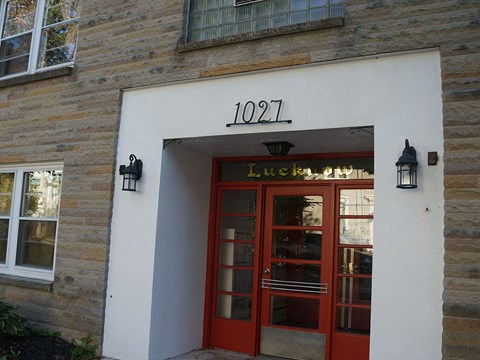 the front of a building with a red door