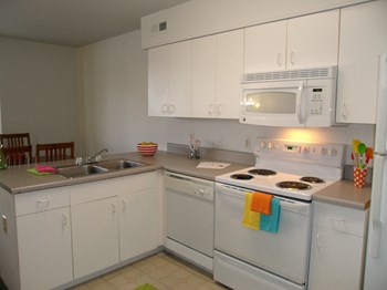 Marshall Park Townhome apartments in Richmond VA Kitchen Kitchen with white and cabinetry and electric stove in Marshall Park Townhome apartments in Richmond VA - Photo Gallery 4