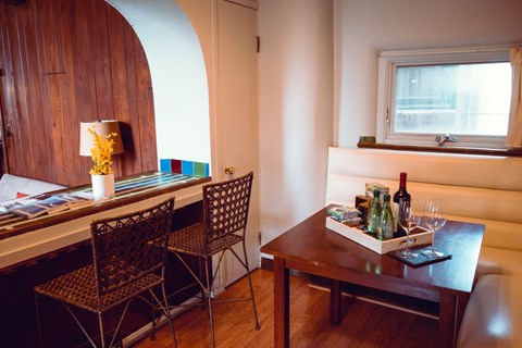 a dining room with a table and chairs and a window
