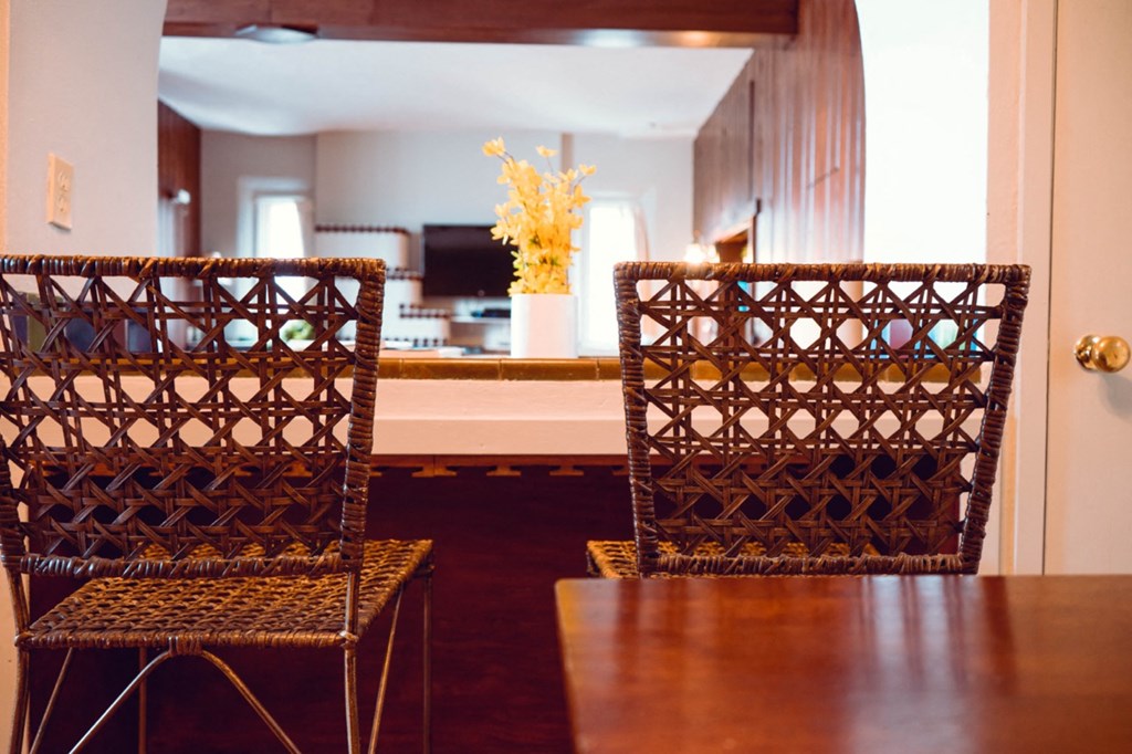 a dining room with two chairs and a table
