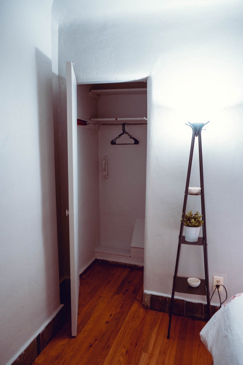 a small bathroom with a ladder and a closet