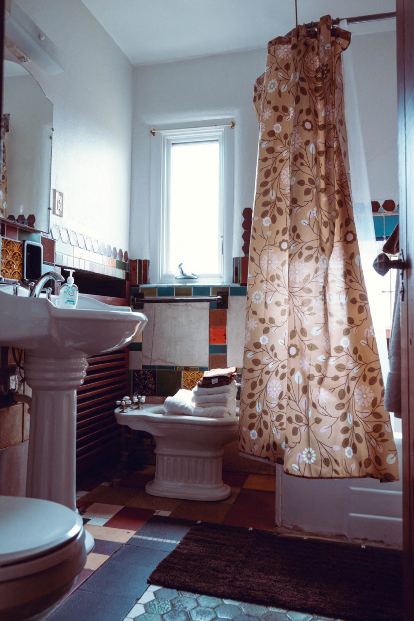 a bathroom with a shower curtain and a toilet and a sink