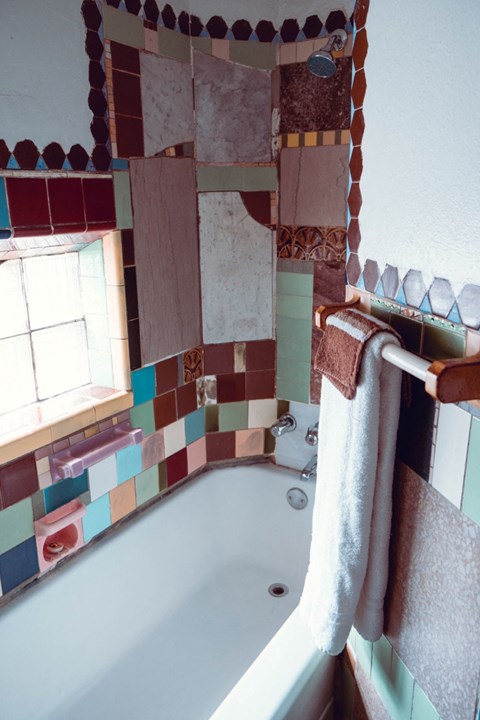 a bathroom with a tub and a towel on a towel rack