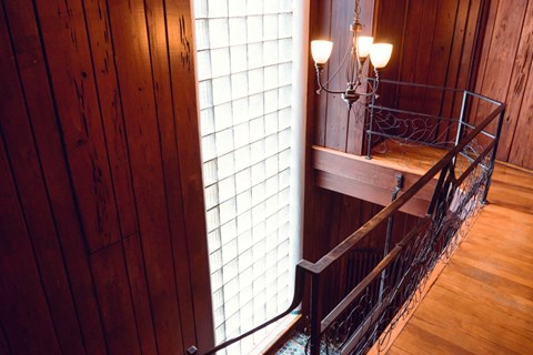 a stairwell with a large window and a wrought iron railing