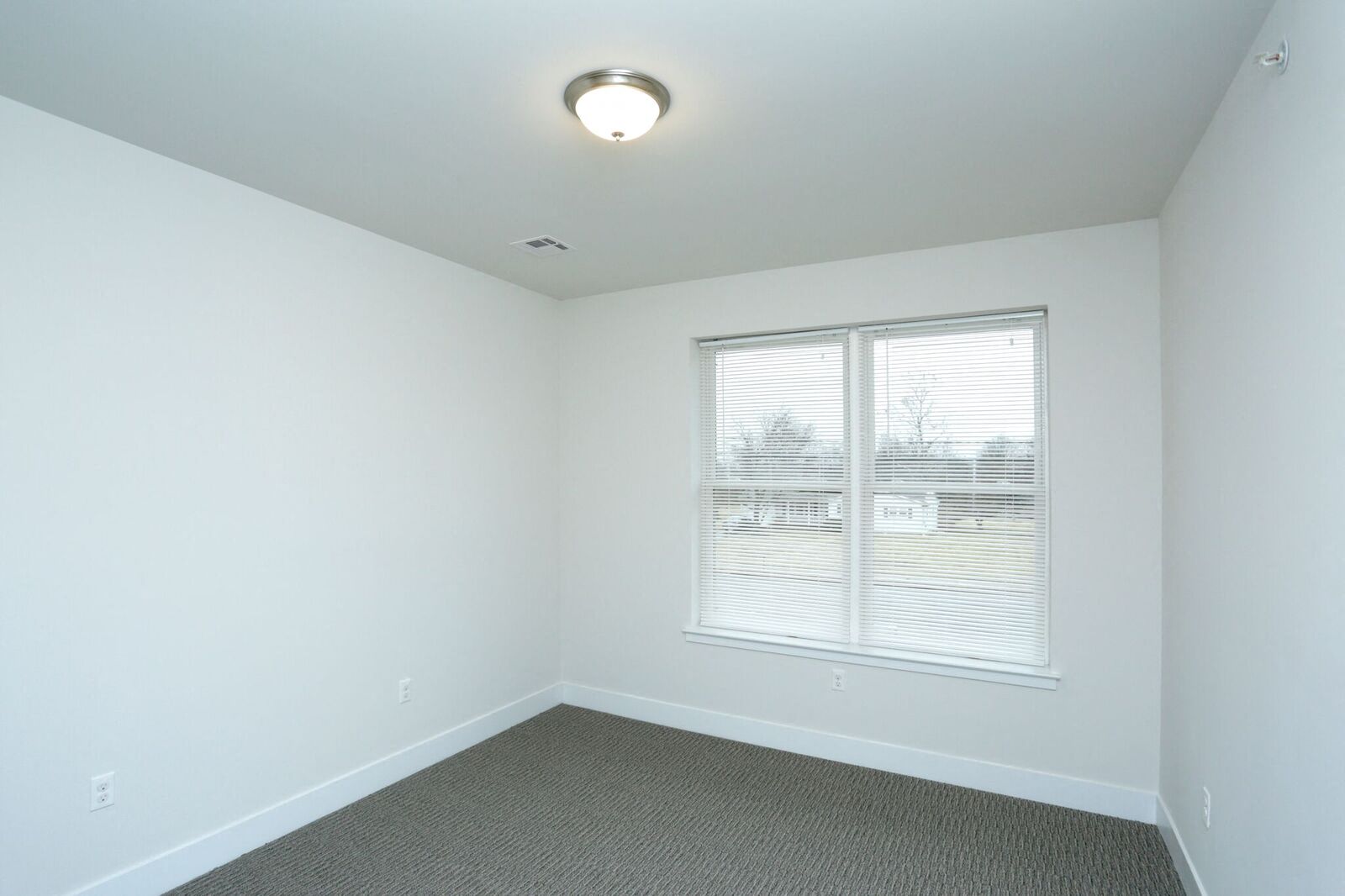 bedroom with white walls and carpeted floors
